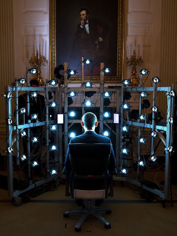 former president Barak Obama sitting in the center of a light stage